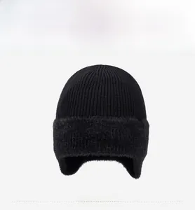 Détail du bonnet en tricot noir avec doublure épaisse en fausse fourrure et étiquette FBXS