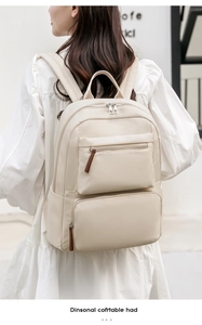 Detail of minimalist beige nylon backpack with double front zippers and leather pulls