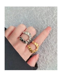 Detail of gold and silver irregular crinkle rings with lava texture on fingers