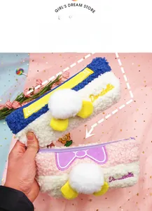 Detail of plush pencil case with Donatella embroidery and a cute 3D fluffy tail