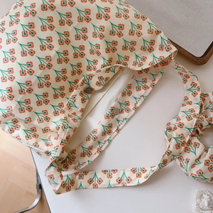 Detail of floral cotton tote bag showing magnetic closure and interior pocket layout