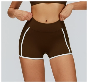 Close-up of high-waisted dark brown yoga shorts with white contrast trim and elastic fabric