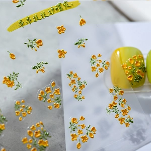 3D floral nail art stickers featuring yellow flowers and green leaves on yellow manicure