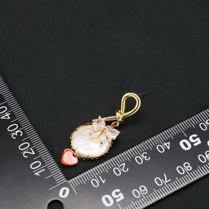 Golden baroque pearl drop earrings with red heart charm and zircon floral accents