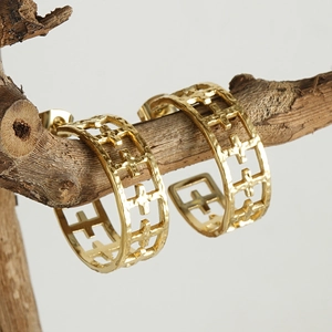 Classic gold-plated C-shaped hoop earrings with hollow cross patterns on a branch