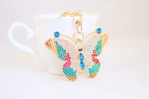 Detailed close-up of butterfly keychain with colorful enamel and sparkling rhinestones