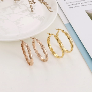 Macro shot of 4mm twisted hoop earrings in gold and rose gold titanium steel finishes