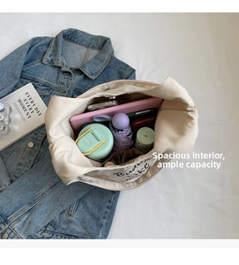 Spacious interior of canvas tote bag showing large capacity for tablet and daily items