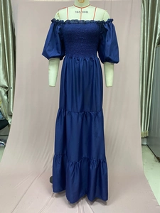 Close-up of smocked bodice and tiered ruffle hem on this navy floral maxi dress