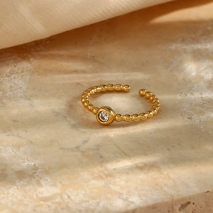 Detail of 18K gold plated bead band ring with a sparkling round zircon center stone