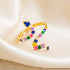 Detailed macro of 18k gold plated snake rings with colorful enamel on silk background