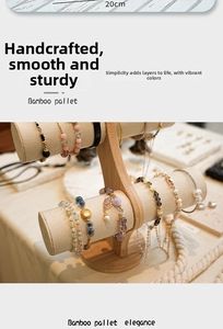 Detailed view of a two-tier bamboo jewelry T-stand displaying various bracelets and watches