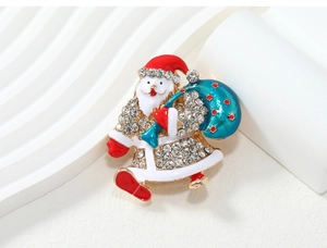 Detailed close-up of retro enamel Santa Claus brooch with sparkling rhinestones decoration