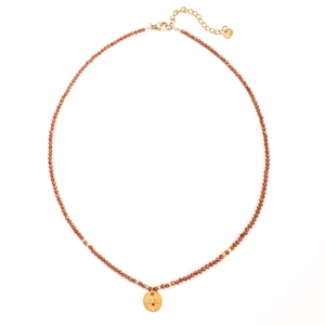 Detail view of retro sun and moon brass pendant necklace with natural stone beads