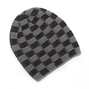Detailed view of winter knit beanie with black and grey checkerboard pattern and soft lining