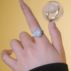 Macro detail of silver heart ring with sparkling micro-pave cubic zirconia setting