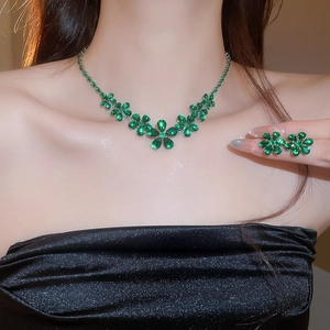 Detail of emerald green zircon flower jewelry set including necklace and stud earrings