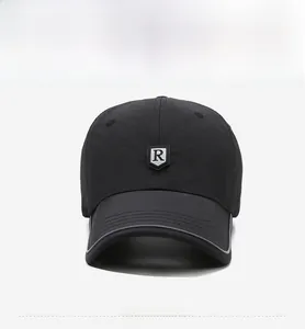 Detail of black quick-dry baseball cap featuring a 3D R-logo and silver trimmed brim