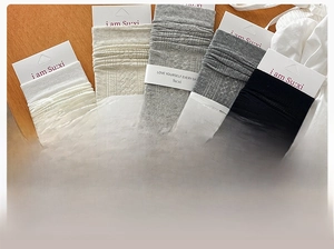 Detailed view of five color knitted slouch socks with intricate hollow patterns and textures