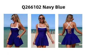 Navy blue one-piece swimsuit with white contrast straps and pleated A-line skirt with pockets