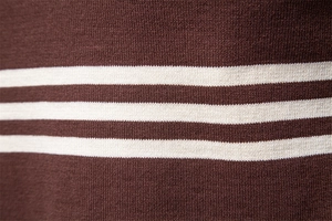 Macro detail of tan and oatmeal striped knit fabric texture on men's polo sweater