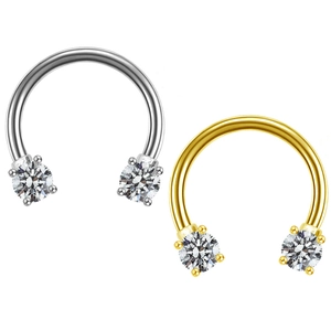 Detail of silver and gold horseshoe nose rings with sparkling cubic zirconia stones