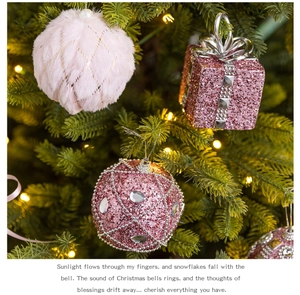 Detailed view of pink foam Christmas ball ornaments with glitter and plush texture on a tree