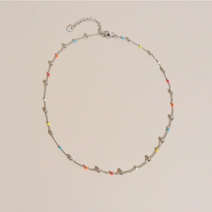 Colorful beaded stainless steel necklace with S925 stamp on a warm beige background