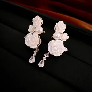 Elegant white rose and pearl drop earrings with zircon teardrop in a light gold finish
