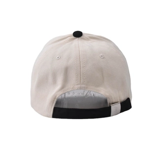 Detail of adjustable metal buckle and black strap on beige washed cotton baseball cap
