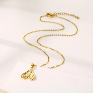 Golden heart pendant necklace with zircon stones on a fine adjustable metal chain
