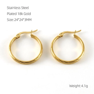 Macro shot of 18k gold plated stainless steel hoop earrings with textured twist pattern