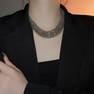 Close-up of a silver heavy industry spring necklace with creative metallic fringe design