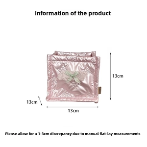 Close-up of pink quilted fabric storage box with green plaid bow and lace detail