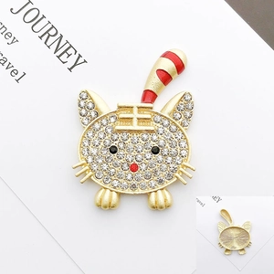 Detail of tiger-shaped alloy pin featuring sparkling rhinestones and red stripes
