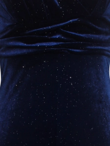 Macro detail of dark blue velvet fabric with silver glitter particles and soft draping