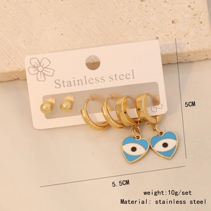 Detailed set of stainless steel earrings featuring a blue heart evil eye charm and gold studs