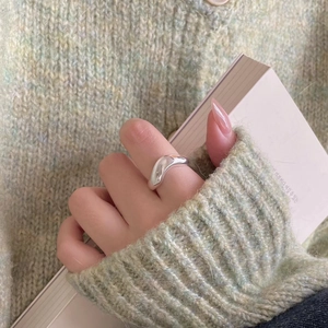 Elegant minimalist 925 sterling silver curved ring worn with a casual knit background