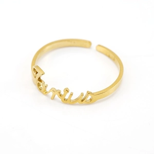 Detailed close-up of golden stainless steel Taurus zodiac open ring on white background