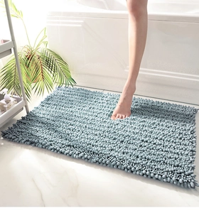 Close-up of blue chenille bathroom mat featuring thick absorbent microfiber texture