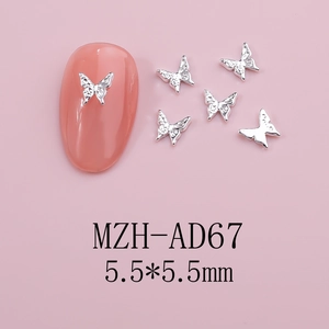 Detail of 5.5mm silver butterfly nail charms with 3D texture on light pink base