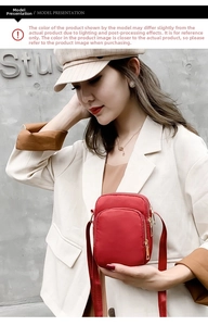 Model wearing a red nylon crossbody phone bag with multi-layer zippers and metal hardware