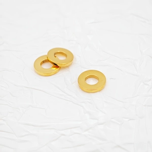 Macro shot of three polished gold titanium steel rectangular spacer beads for jewelry DIY