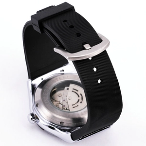 Detail view of the silver automatic watch skeleton back with black rubber strap