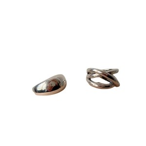 Chic silver cross-line and smooth curved metal rings on a clean white background