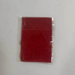Close-up of a red felt envelope Christmas ornament with a gold string in clear packaging