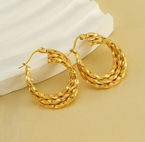 Detailed close-up of 18K gold-plated twisted rope hoop earrings with a secure latch closure
