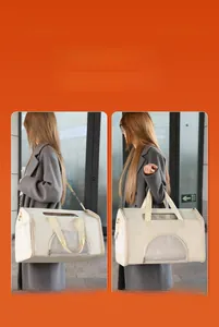 Detail of cream pet carrier bag showing dual carrying modes with shoulder strap and handles
