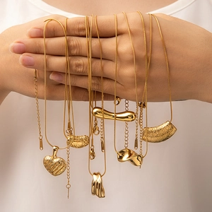Minimalist gold titanium steel necklaces featuring organic geometric lava texture pendants
