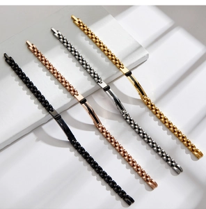 Detail of four stainless steel watch-style link bracelets in gold, silver, rose gold, and black